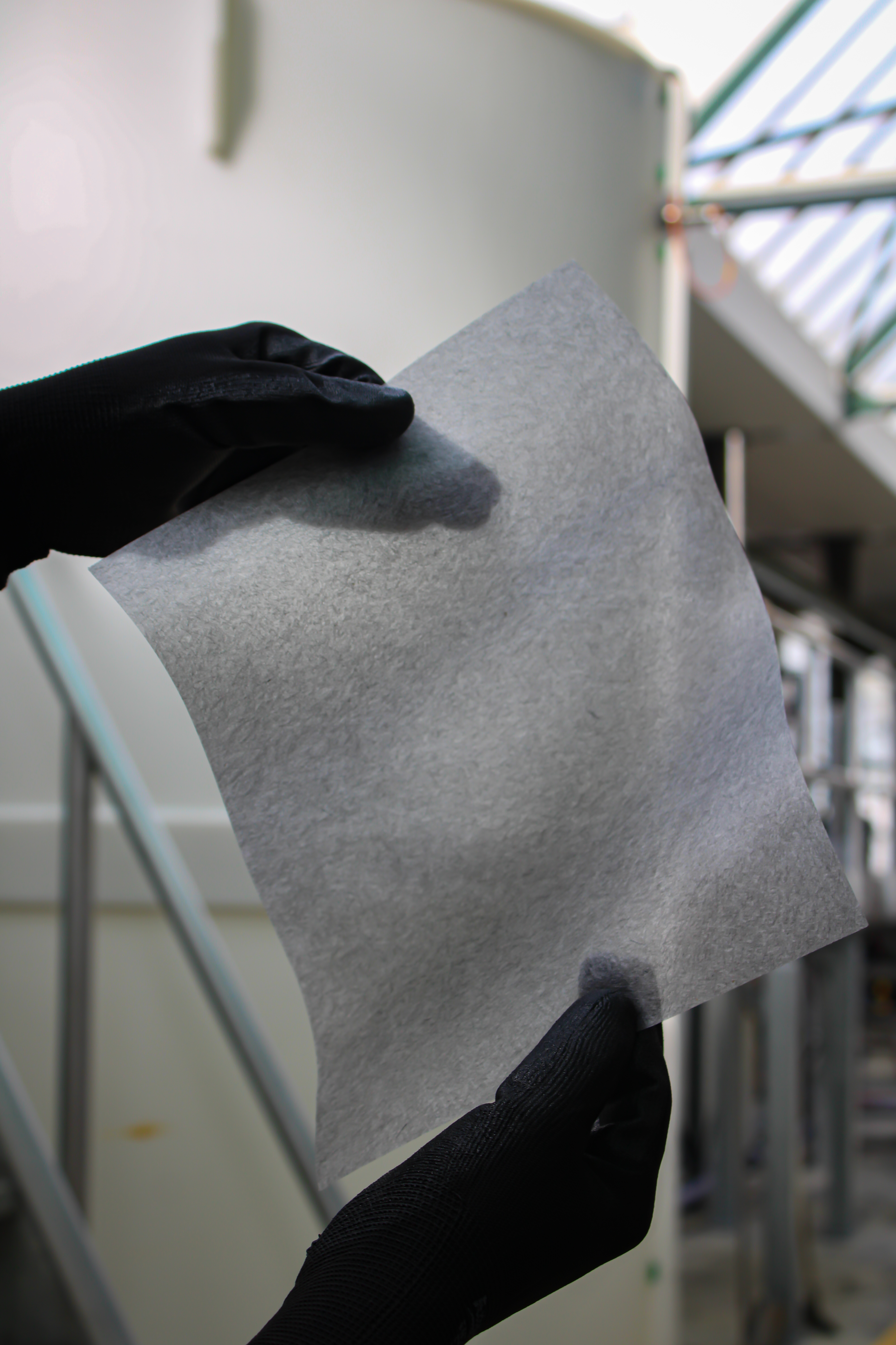 Finished wet-laid nonwoven sheet held up inside the Phoenix Non Woven production facility